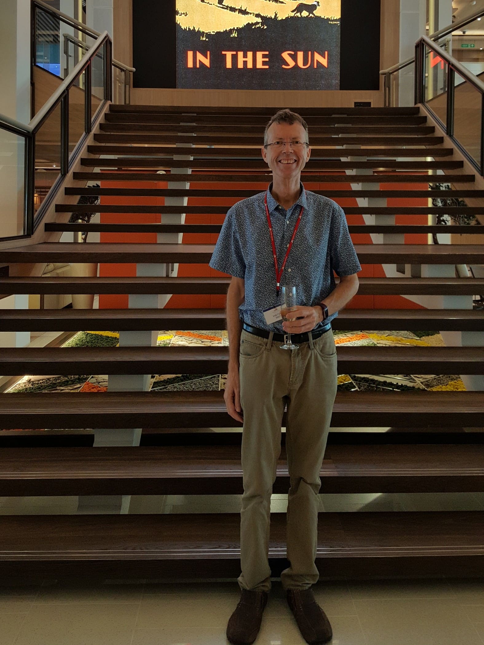 Philip Clape in front of Grand Staircase on Viking Sun